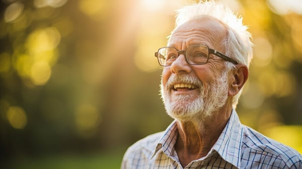 Senior man checking blood pressure with monitor at home - treatment of hypertension for seniors